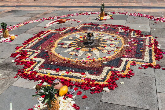 The Chakana, or Andean Cross, made of flower petals, grains, and seeds. It is a spiritual ritual performed in Ecuador during ceremonies Inti Raymi to honor Pachamama (Mother Earth). Cuenca, Ecuador