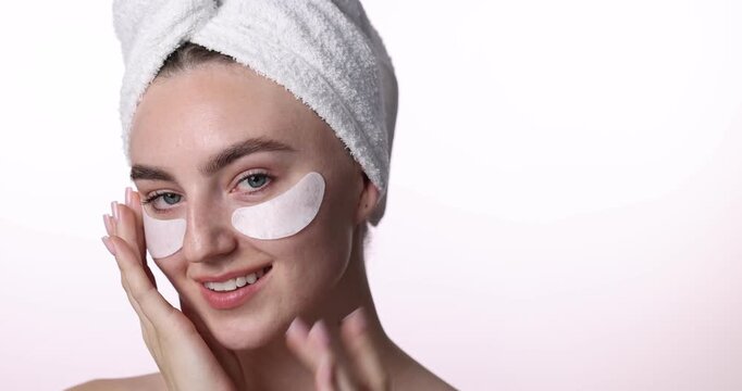 Beautiful woman with eye patches on white background