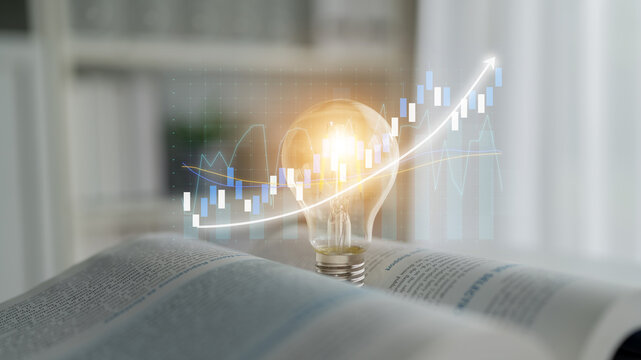 An illuminated light bulb rests over an open book, surrounded by animated financial graphs, representing the intersection of learning, innovation, and business strategy. Impute