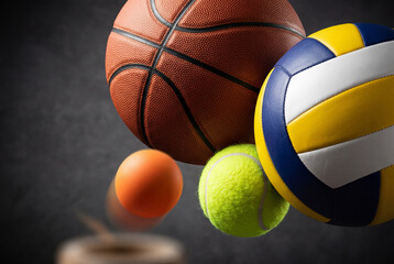 Fototapeta premium Dynamic studio arrangement of assorted sports balls including basketball volleyball and tennis ball