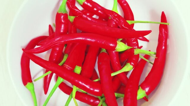 Fresh red chili peppers in white bowl close up
