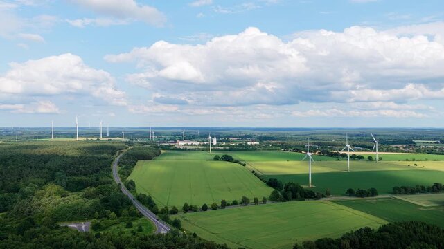 Agricultural harvest. Crop cultivation. Wind turbines farm. Green energy. Wind mill renewable electric energy production. Wind mill for renewable electric energy production. Windmill in rural area