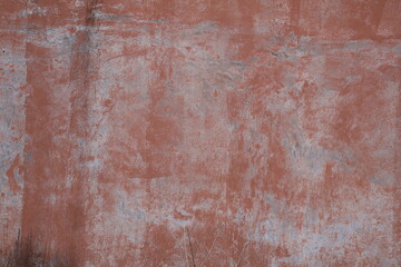 Fototapeta premium Weathered wall with peeling paint revealing aged surface