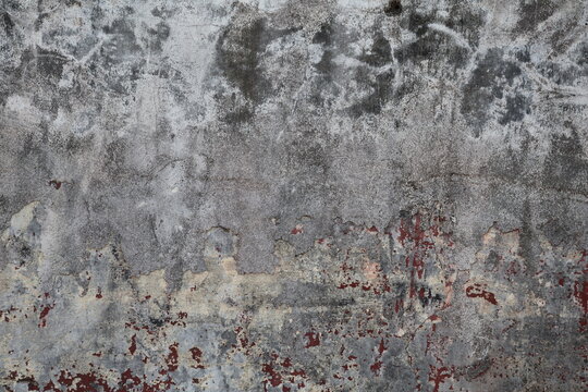 Weathered wall with peeling paint revealing aged surface