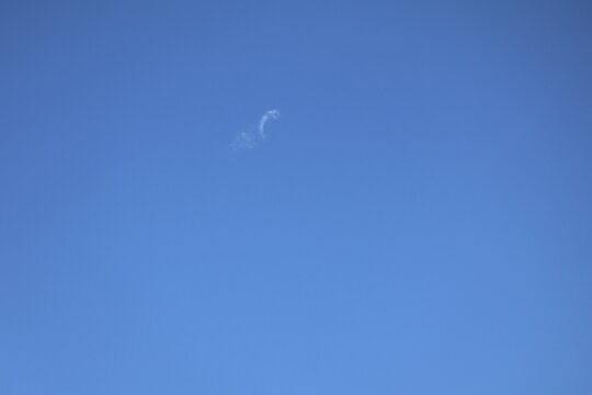 Clear blue sky with delicate wispy white clouds