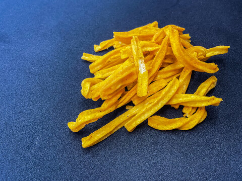 A pile of crispy, golden-yellow Punjabi Tadka Namkeen and seasoned soya sticks, a popular traditional Indian tea-time savory snack. These crunchy 