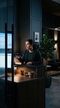 Professional Receptionist Assisting Visitor At Modern Office Desk