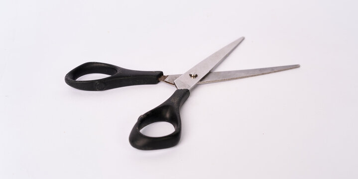 Angled view of open scissors with black handles isolated on white background
