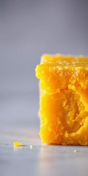 Close-up shot of a single Mysore Pak piece with crispy edges and gooey center, golden, single