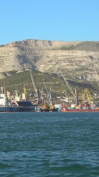 Port Novorossiysk with cargo cranes and cement plant by the Black Sea