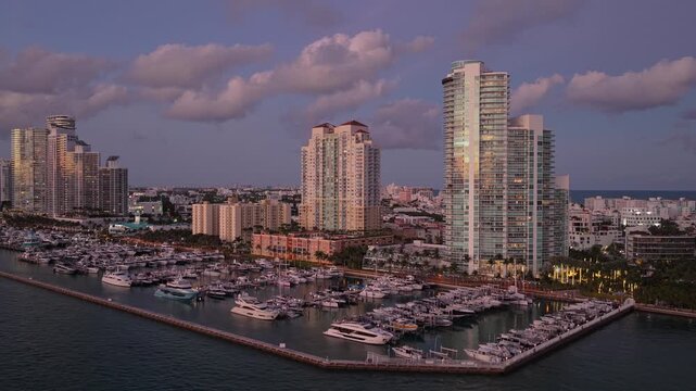 Luxury South beach marina. Luxury yacht. Miami south beach view. Yacht club. Marina in Miami, Florida on sunset. Tropical waterfront sunset. Miami marina with luxury yacht. Summer sunset vacation