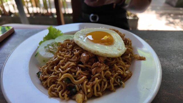 Indonesian mie goreng fried noodles topped with a fried egg