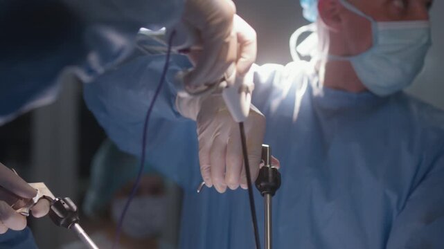 Close Up Of Surgeons Using Advanced Surgical Equipment During Operation 4K