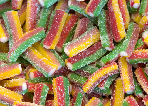 Close up of small pieces of licorice in multiple colors. Yellow, green and red. Sweet treat.