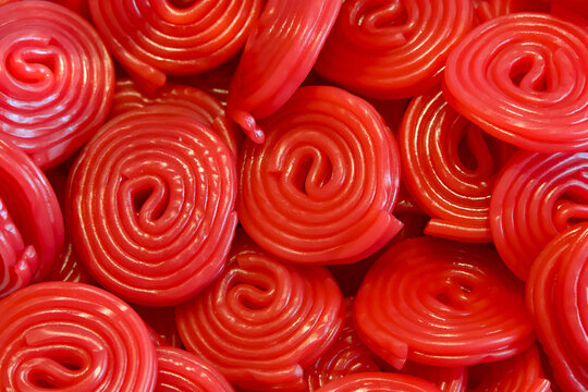 Close up on rolls of red licorice candy, piled. Above top view.