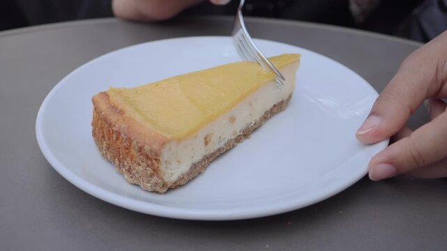 Enjoying a slice of cheesecake on a sunny afternoon