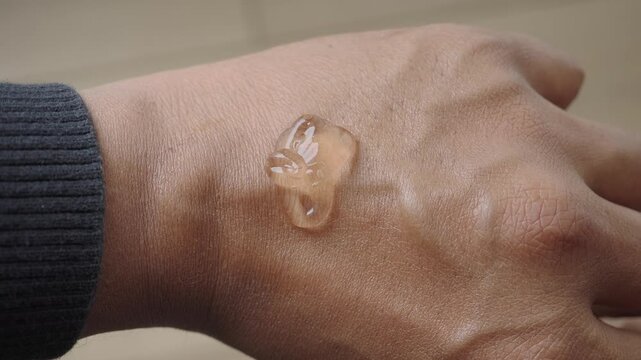 Applying gel to hand on a flat surface