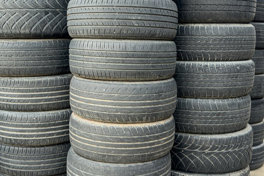 Stacked used car tires for recycling and pollution control.