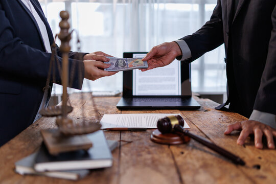 Corrupt official receiving illegal money from a dishonest businessperson, a clandestine payment for unethical legal practices and covert agreements in a law office