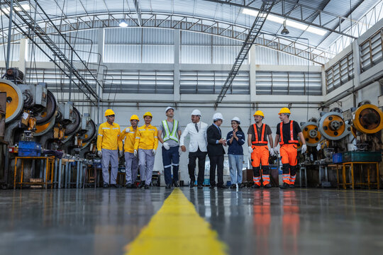 Industrial Management Team Inspecting Modern Manufacturing Facility with Production Engineers