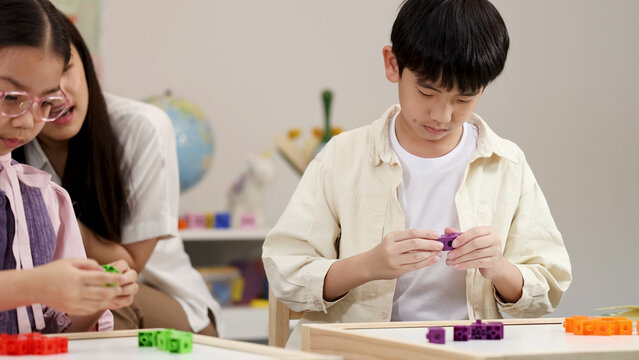 Asian Students and Teacher Using Math Manipulative Blocks in Classroom