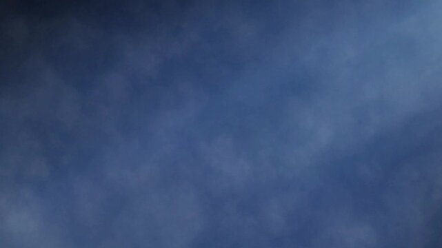 Blue atmosphere features a soft cloud texture that spreads across the dark background to provide a subtle backdrop for creative projects.