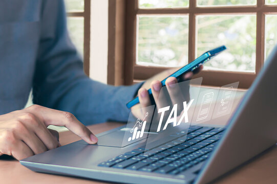 Tax return calculation concept financial research government tax businessman using laptop filling out income tax form online for payment