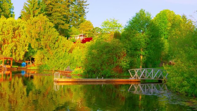 Lakeside wooden swimming dock and bridge during golden hour sunset