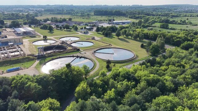 Modern water treatment facility with circular clarifier tanks from drone