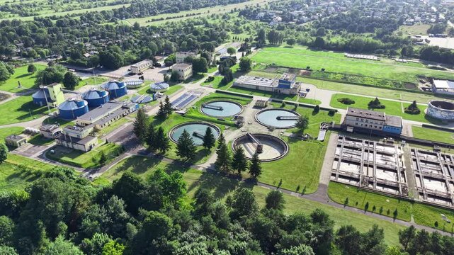 Modern water treatment facility with circular clarifier tanks from drone
