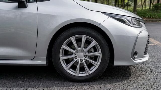 Silver Sedan Car Side View Wheel Close Up Tire Suddenly Braking and Coming to a Halt &ndash; Emergency Stop