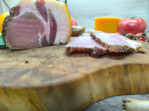dried meat on the table surrounded by vegetables and fruits. High quality photo