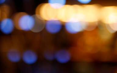 Fototapeta premium Abstract soft defocused bokeh lights with colorful glowing circles and warm illumination. Nightlife, festive background, cinematic overlay, holiday atmosphere, creative backdrop