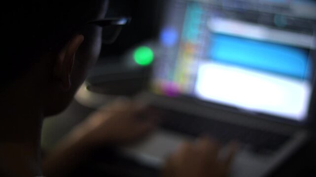 Audio Producer Working on Digital Audio Workstation Software with Laptop
