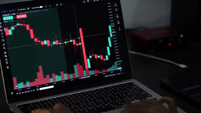 Investor Analyzing Stock Market Candlestick Chart on Laptop Computer