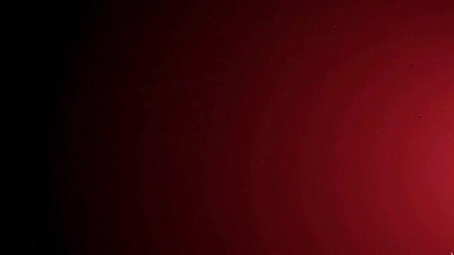 Abstract dark background with soft red light gradient and subtle smoke texture