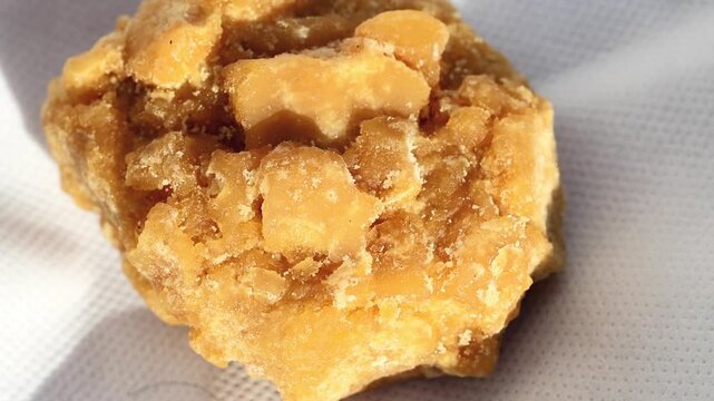 Gorgeous natural sunlight on close Up of Traditional Jaggery Gur Solid Sugar Block 180fps Captured in Cinematic High Detail Footage