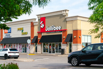 Fototapeta premium Scarborough, ON, Canada - Jun, 26, 2026: Exterior view of Jollibee restaurant located at Eglinton Town Centre, a Filipino fast‑food and quick‑service restaurant with over 1,500 locations worldwide