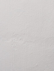Fototapeta premium A clean and subtle full-frame background texture of a painted white concrete wall featuring fine grain and subtle imperfections.