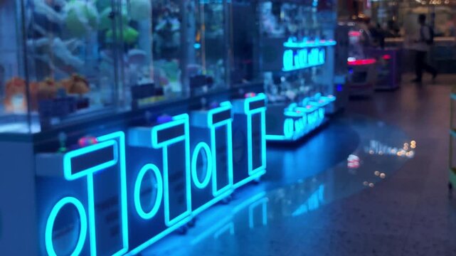 Blurred Defocused Arcade Game Center with Colorful Neon Lights and Claw Machines Background, Bokeh Entertainment Backdrop