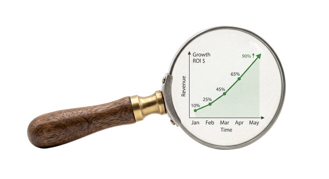 Magnifying glass reveals upward trending revenue and growth chart
