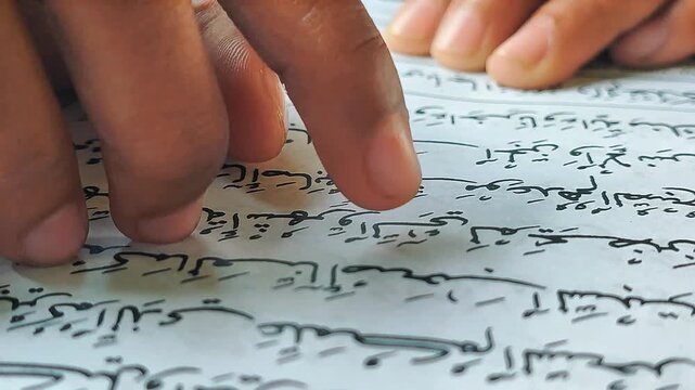 Hand Reading Arabic Quran Text