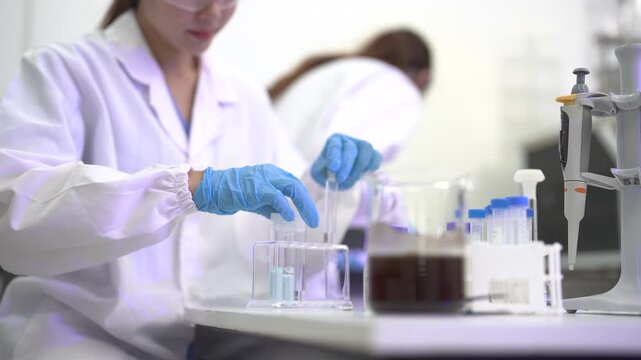 Environmental scientist collecting river water samples for pollution analysis, water quality monitoring, ecological research, sustainability, conservation and field testing.