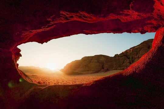 Cinematic view Eye Arch natural rock formation framing sunset wide desert panorama warm sandstone tones tranquil atmosphere Wadi Rum southern Jordan