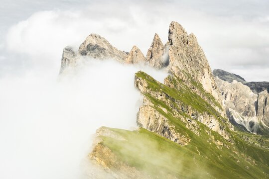 Dramatic Seceda mountain peaks scenic view Dolomites Alps Italy summer daytime green alpine meadow clouds travel destination photography background