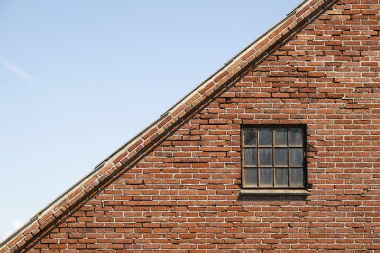 Roof and wall with latticed window, old brick house, farm, Sorteb&aelig;rdalen Strand, Houvig, North Sea, Denmark