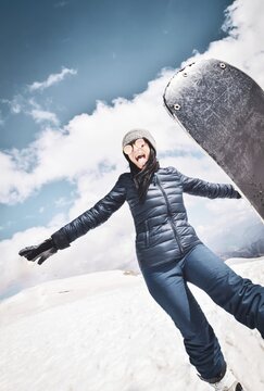 Happy excited cool caucasian brunette woman with skies pose in winter outfit in mountains. Copy paste vertical background top left.Gudauri.Georgia