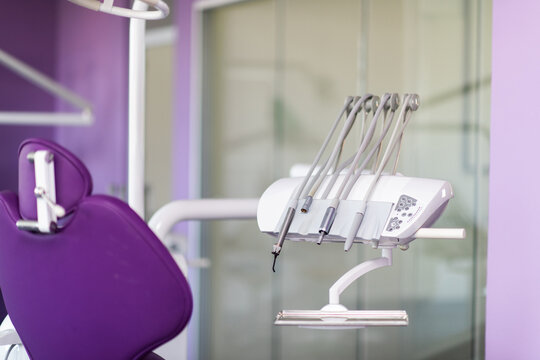 Modern Dental Clinic Interior With Purple Dental Chair and Professional Dental Equipment Close-Up