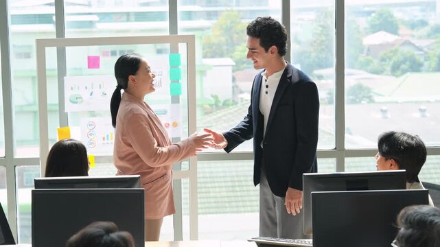Overjoyed diverse businesspeople applaud celebrate company business success at meeting together