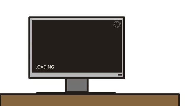 There is a monitor on the table, where a black boot screen is turned on with the word "loading" and a spinning striped symbol in the upper corner.